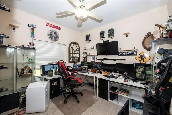 a view of a workspace with furniture and a flat screen tv