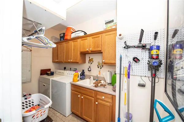 a utility room with fridge dryer and washer