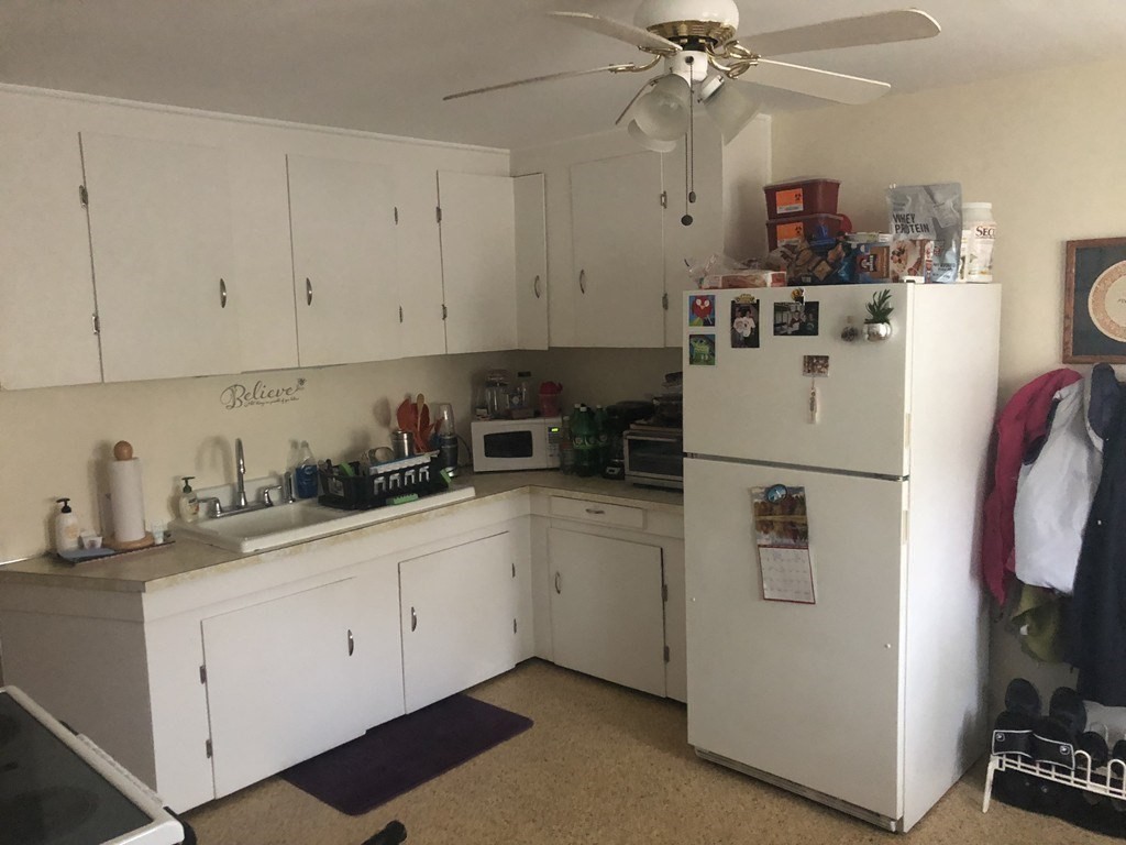 14 Racicot Avenue Webster, MA 01570 - Photo 5 of 12 a kitchen with refrigerator and cabinets