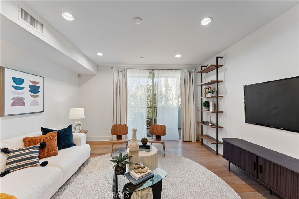 118 North Kings Road, Unit 201 Los Angeles, CA 90048 - Photo 14 of 38 a living room with furniture and a flat screen tv