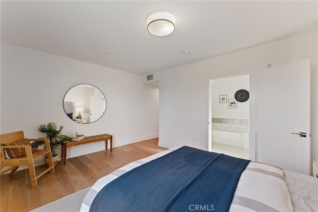 118 North Kings Road, Unit 201 Los Angeles, CA 90048 - Photo 19 of 38 a bedroom with a bed window and a table in it