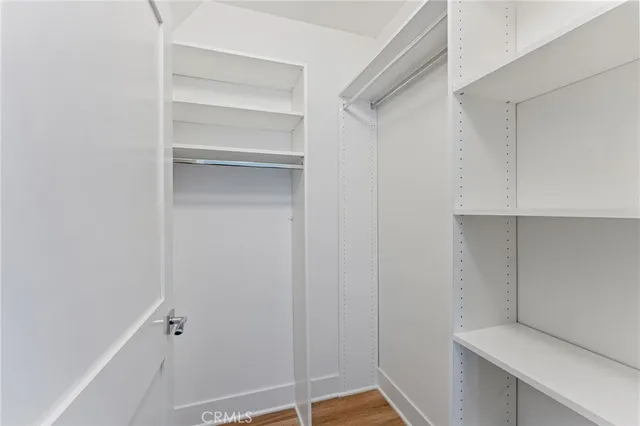 a bedroom with a bed and painting on the wall