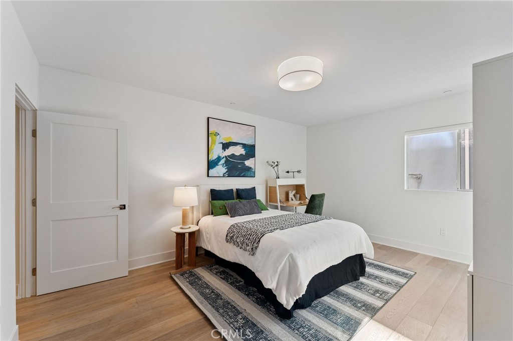 118 North Kings Road, Unit 201 Los Angeles, CA 90048 - Photo 24 of 38 a bedroom with a bed and painting on the wall