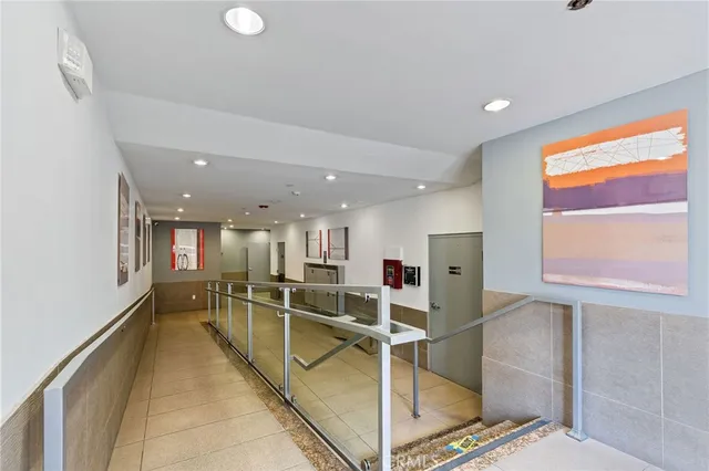 a view of a kitchen with kitchen island a large window appliances and cabinets