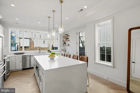 a kitchen with counter top space appliances and a window