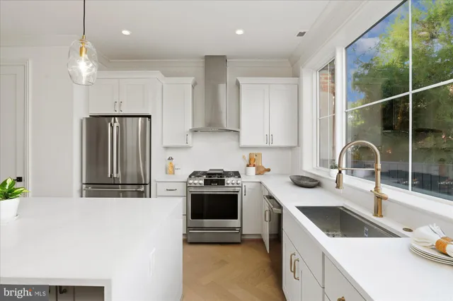 a kitchen that has a sink cabinets counter space and stainless steel appliances