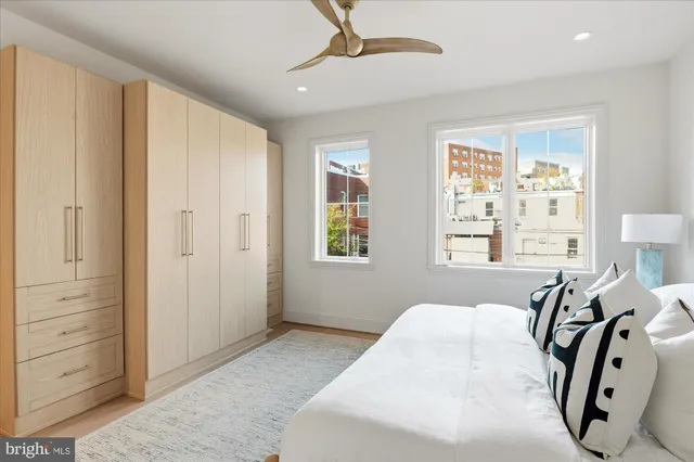 a spacious bedroom with a bed and a window