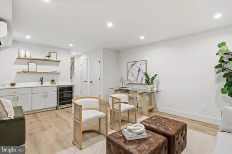 a living room with stainless steel appliances kitchen island granite countertop furniture and a kitchen view