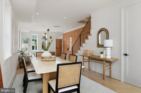 a dining room with furniture and window