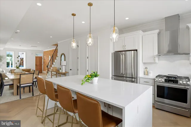 a kitchen with kitchen island a large counter top space appliances and cabinets