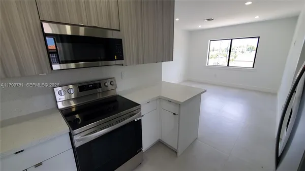a kitchen with a stove and a microwave