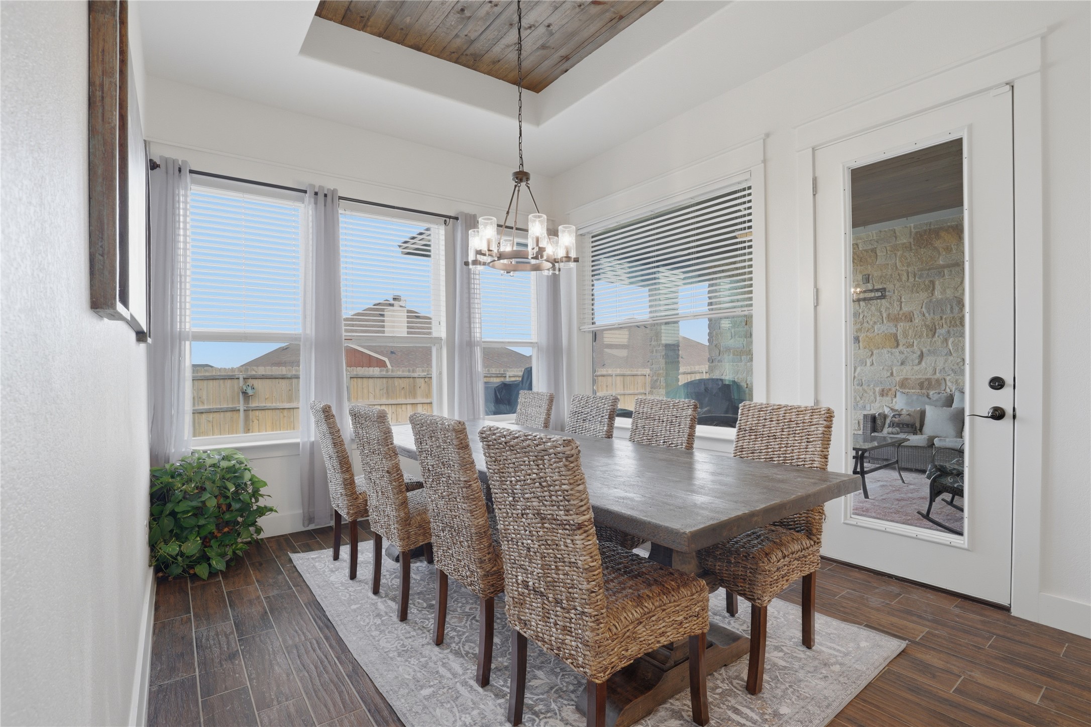 133 Greg Lane Jarrell, TX 76537 - Photo 11 of 24 Dining area featuring wood-finish flooring, a wood plank ceiling treatment, and a contemporary chandelier