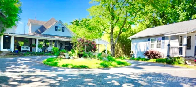 a front view of a house with a garden and plants