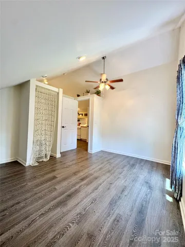 a living room with furniture and potted plants
