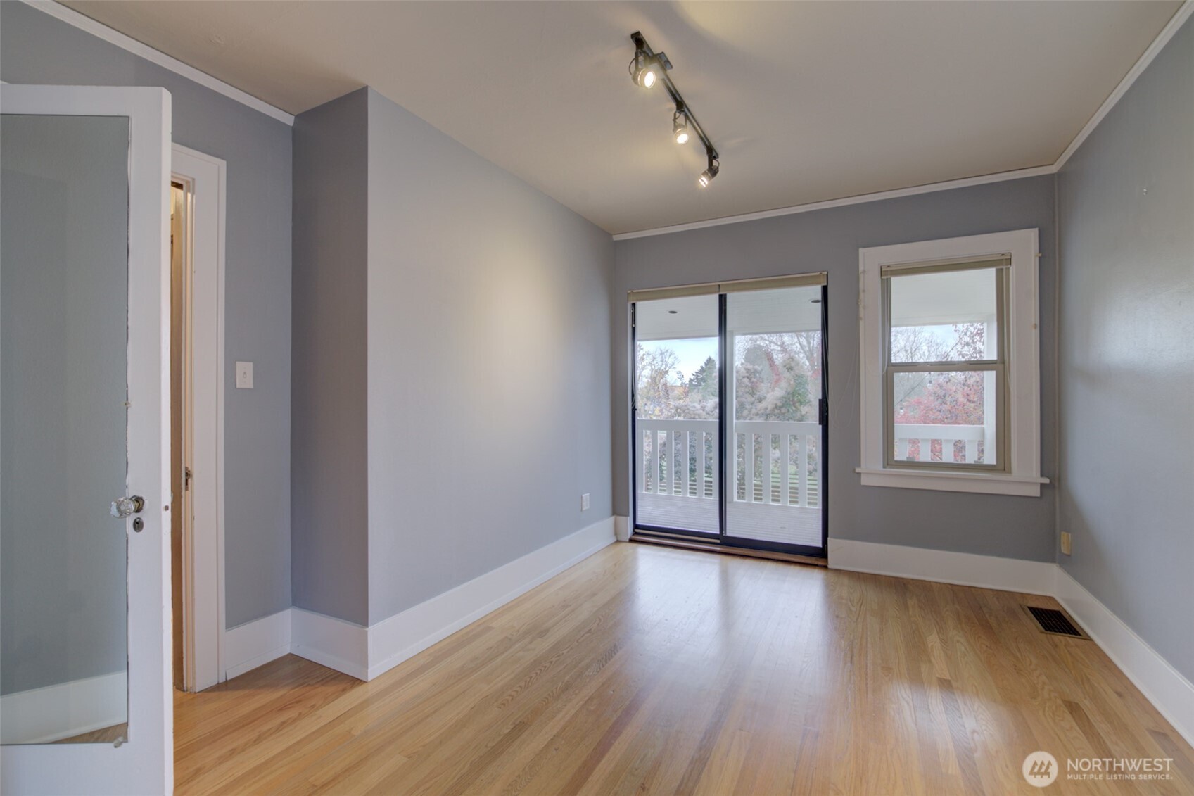 357 29th Avenue Seattle, WA 98122 - Photo 17 of 31 an empty room with wooden floor and windows