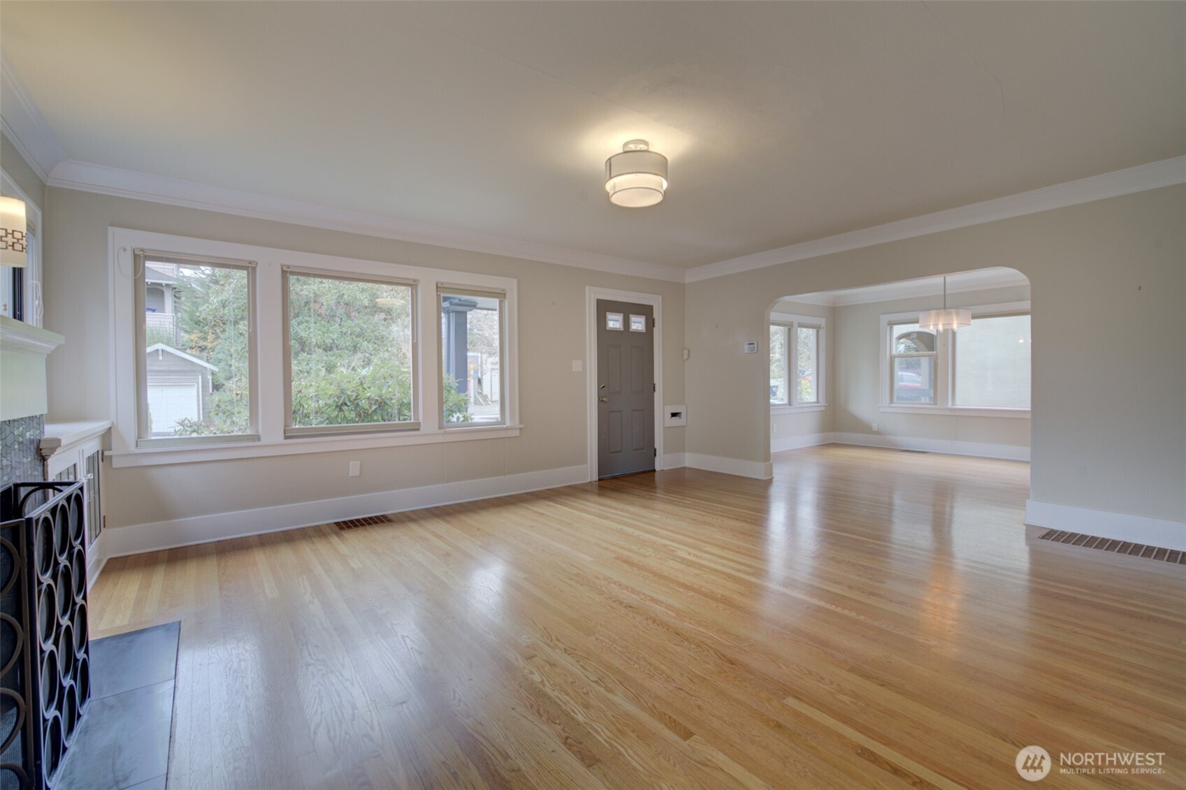 357 29th Avenue Seattle, WA 98122 - Photo 5 of 31 an empty room with wooden floor and windows