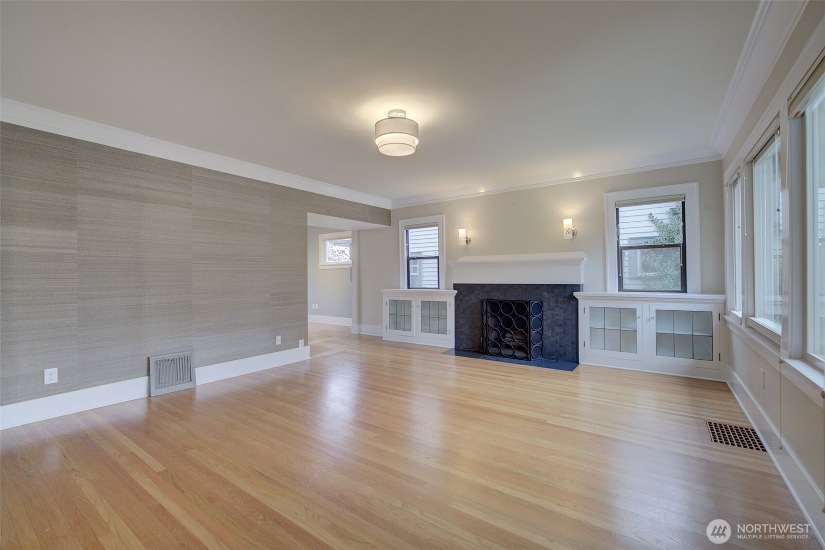 357 29th Avenue Seattle, WA 98122 - Photo 7 of 31 an empty room with windows and fireplace