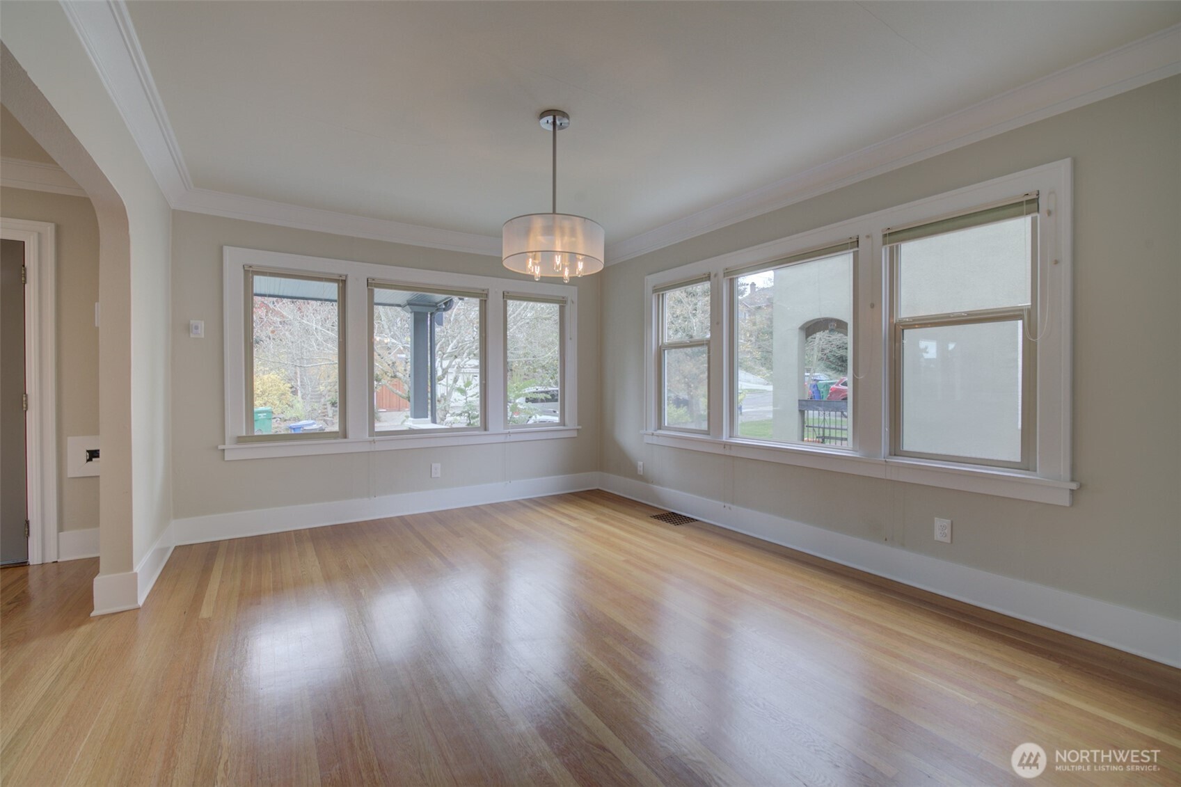 357 29th Avenue Seattle, WA 98122 - Photo 8 of 31 a view of an empty room with wooden floor and a window