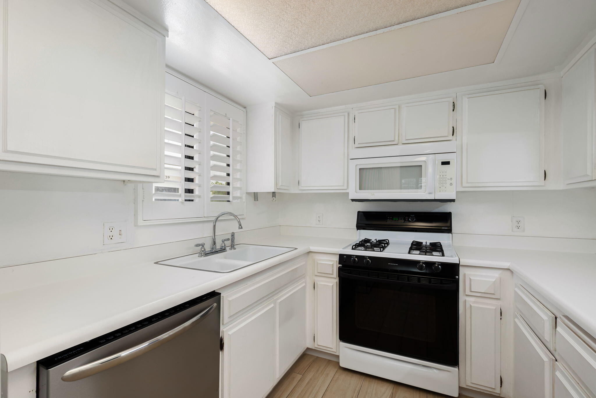 1150 East Palm Canyon Drive, Unit 37 Palm Springs, CA 92264 - Photo 12 of 40 a kitchen with a sink stove and cabinets