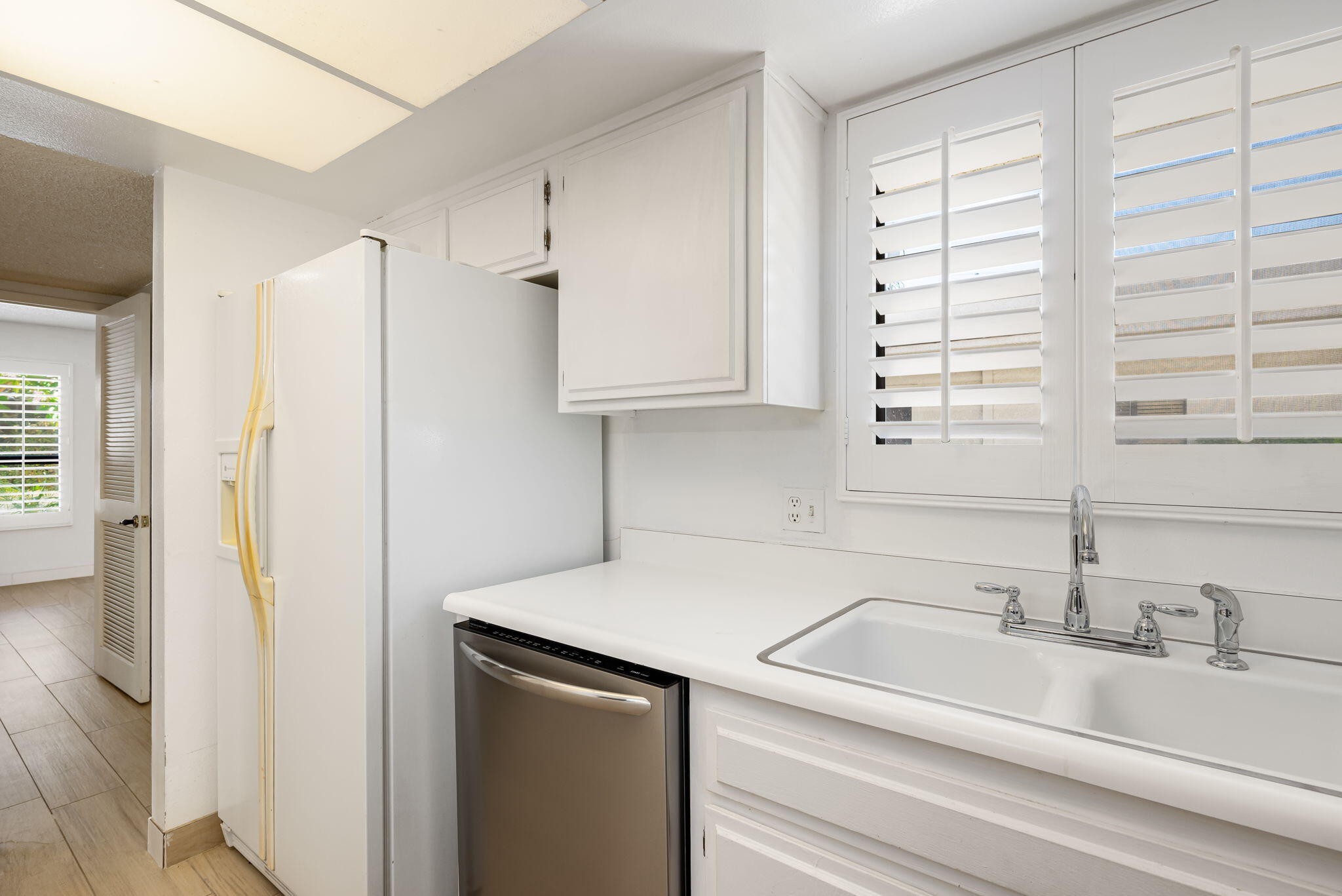 1150 East Palm Canyon Drive, Unit 37 Palm Springs, CA 92264 - Photo 14 of 40 a kitchen with a sink cabinets and a refrigerator