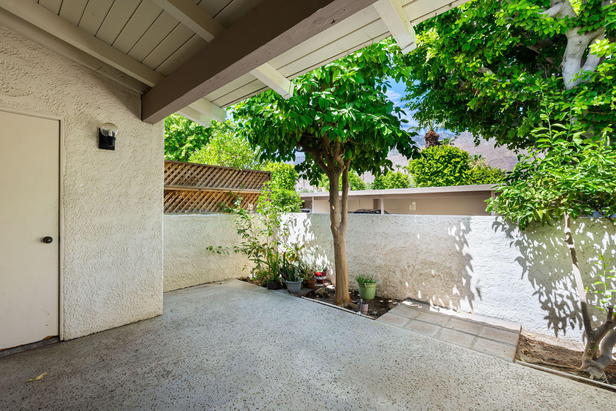 1150 East Palm Canyon Drive, Unit 37 Palm Springs, CA 92264 - Photo 18 of 40 a view of a house with a tree and garage