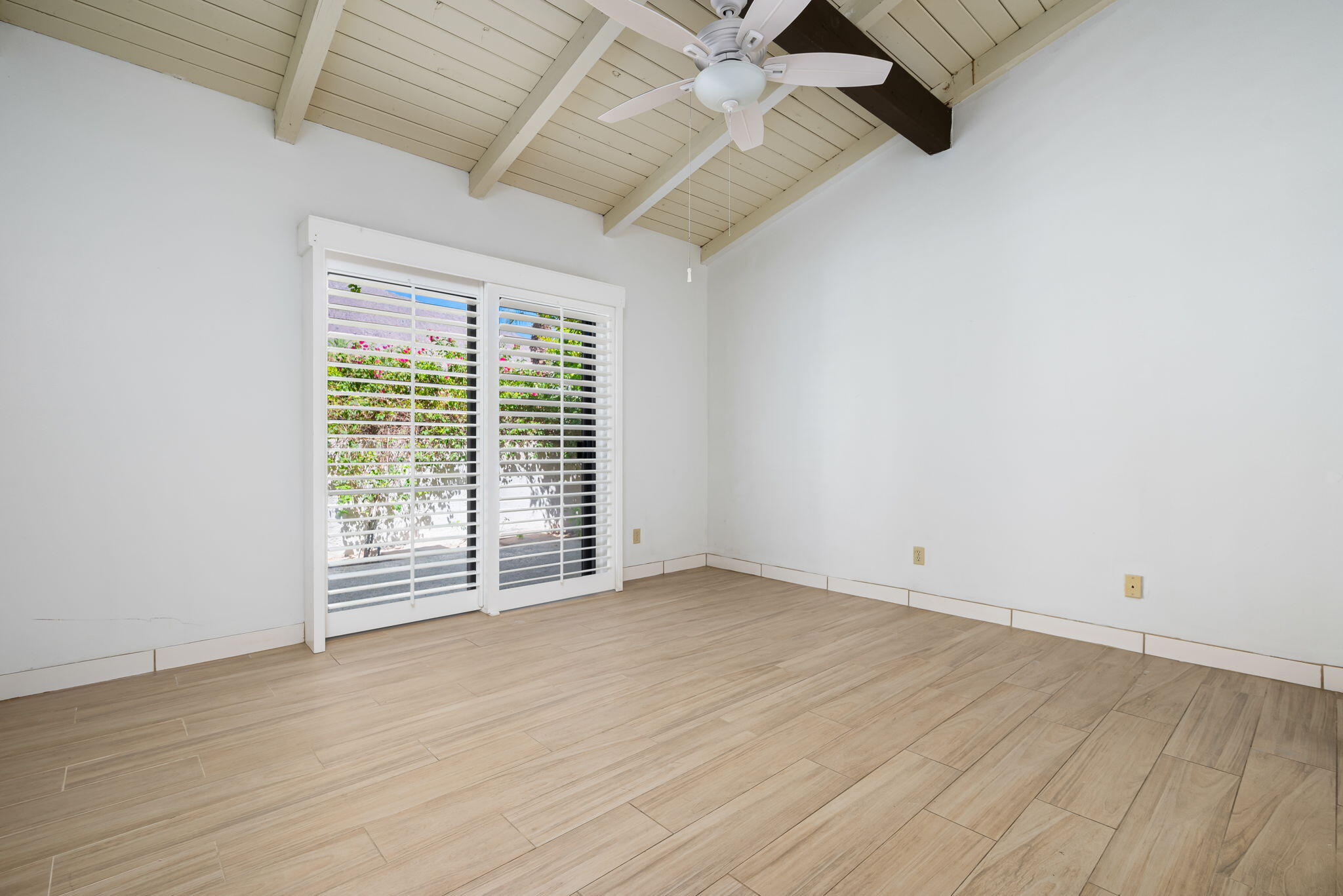 1150 East Palm Canyon Drive, Unit 37 Palm Springs, CA 92264 - Photo 25 of 40 an empty room with wooden floor and windows