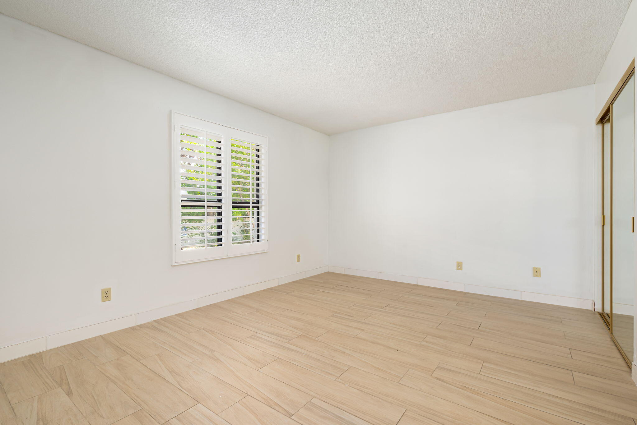 1150 East Palm Canyon Drive, Unit 37 Palm Springs, CA 92264 - Photo 30 of 40 a view of an empty room with wooden floor and a window
