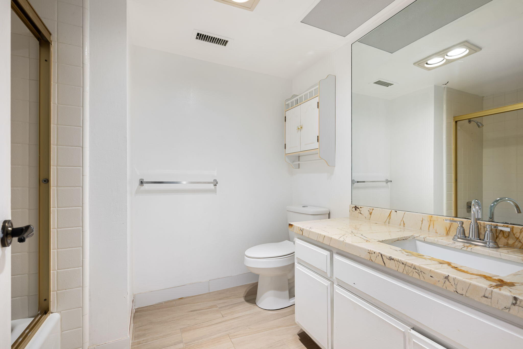 1150 East Palm Canyon Drive, Unit 37 Palm Springs, CA 92264 - Photo 31 of 40 a bathroom with a granite countertop sink a toilet and a mirror