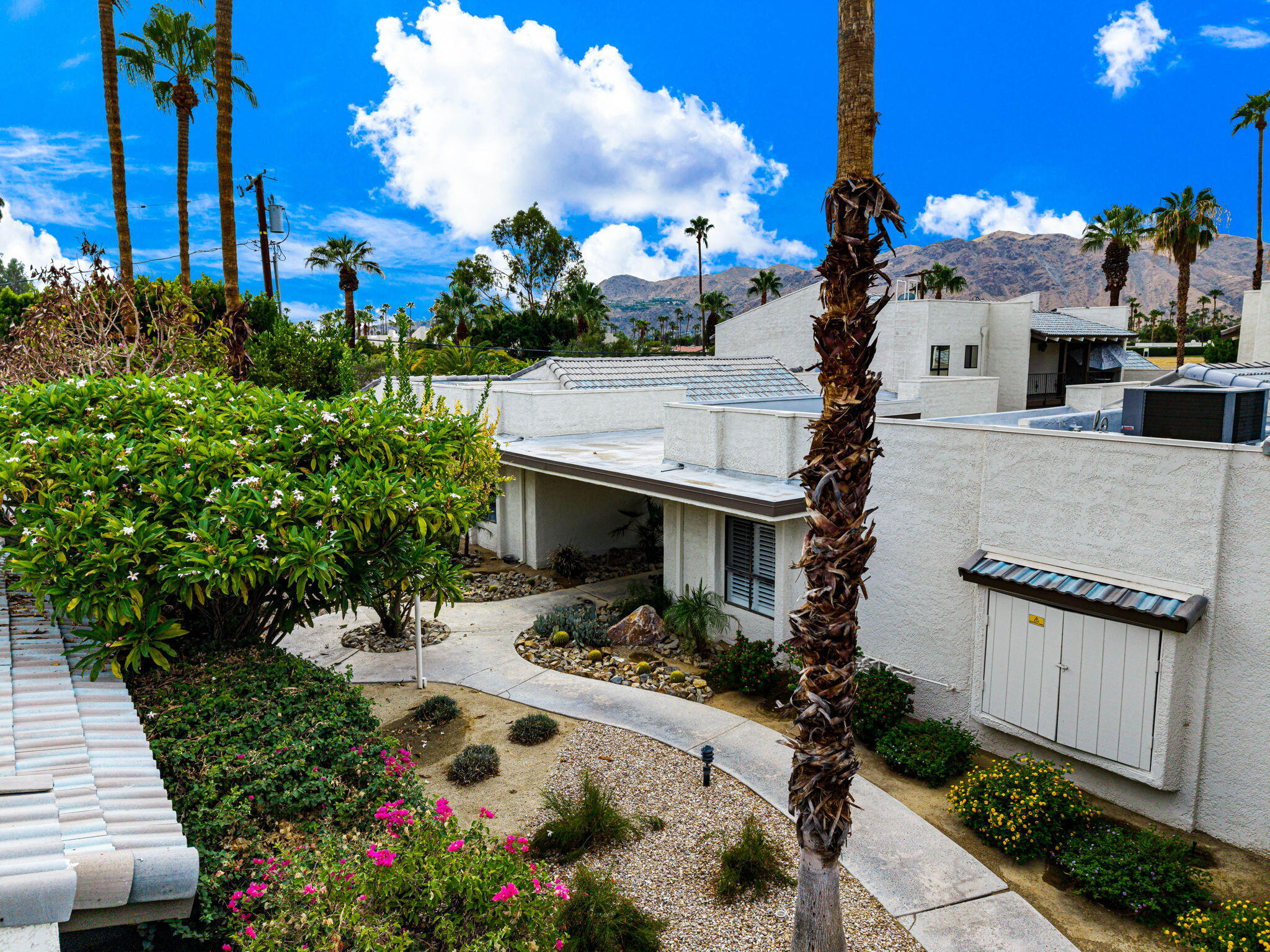 1150 East Palm Canyon Drive, Unit 37 Palm Springs, CA 92264 - Photo 34 of 40 a front view of a house with a yard
