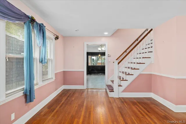 a view of entryway and hall with wooden floor