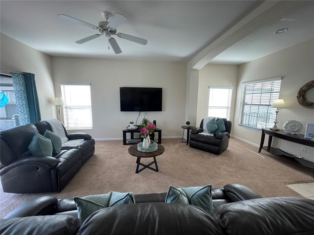 141 Summer Pl Loop Clermont, FL 34714 - Photo 11 of 63 a living room with furniture and a flat screen tv