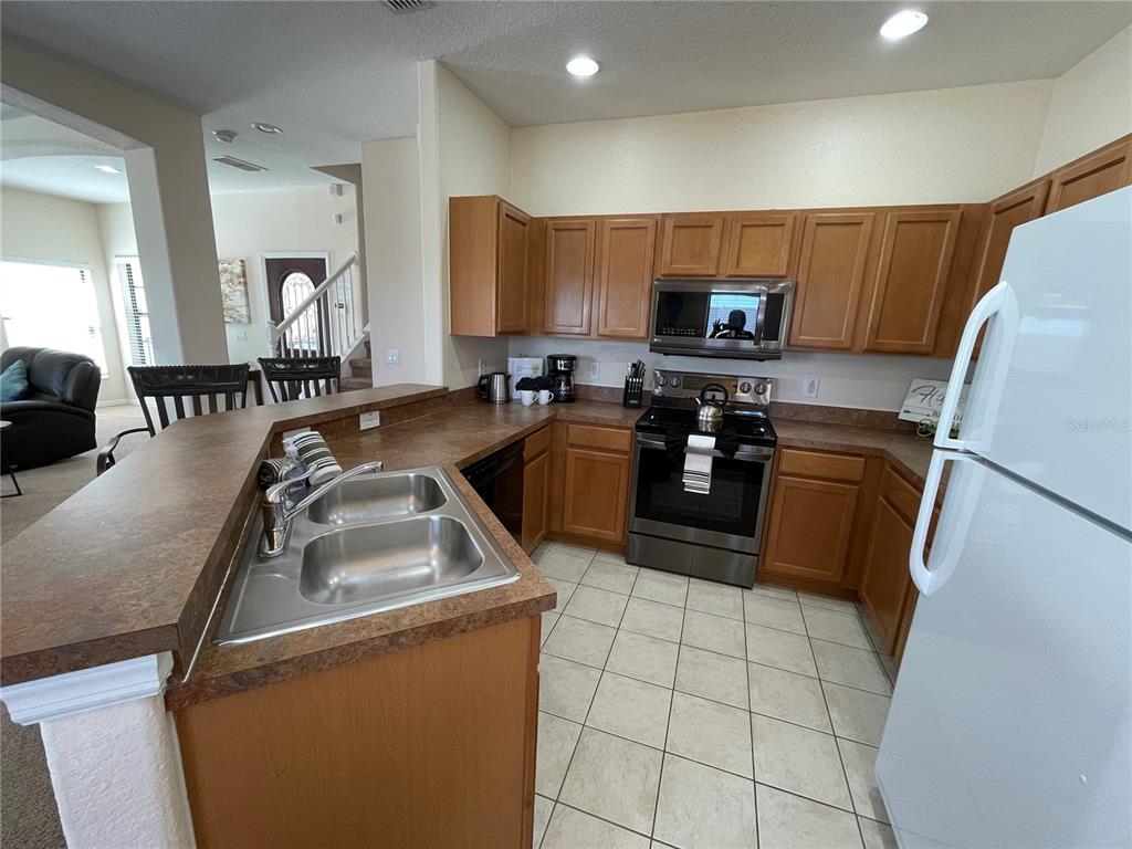 141 Summer Pl Loop Clermont, FL 34714 - Photo 15 of 63 a kitchen with a sink a stove a refrigerator and a sink