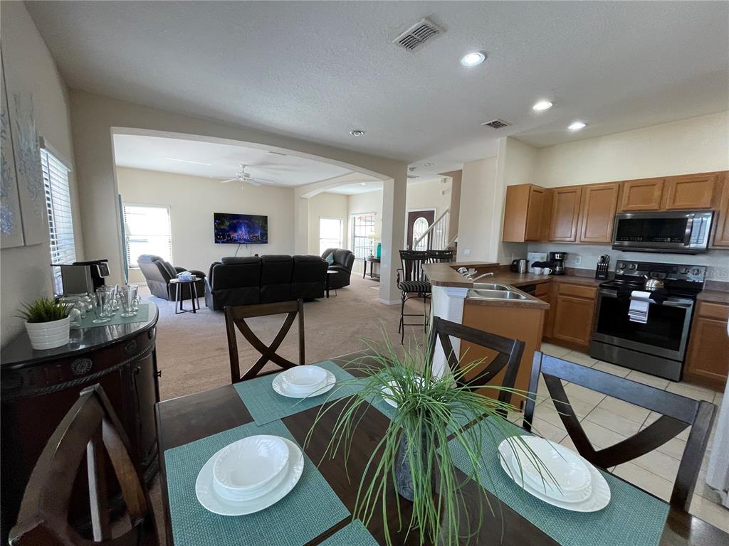 141 Summer Pl Loop Clermont, FL 34714 - Photo 18 of 63 a living room with furniture a flat screen tv and kitchen view
