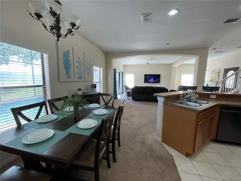 141 Summer Pl Loop Clermont, FL 34714 - Photo 19 of 63 a view of a dining room with furniture and a chandelier