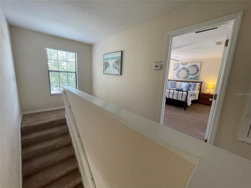 141 Summer Pl Loop Clermont, FL 34714 - Photo 21 of 63 a view of a bedroom with wooden floor and a window