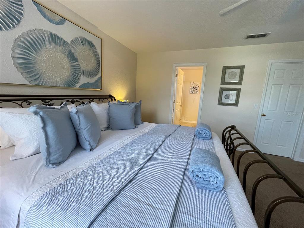 141 Summer Pl Loop Clermont, FL 34714 - Photo 22 of 63 a bedroom with a bed and wooden floor