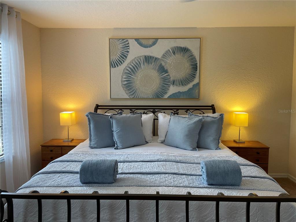 141 Summer Pl Loop Clermont, FL 34714 - Photo 27 of 63 a bedroom with a bed and painting on the wall