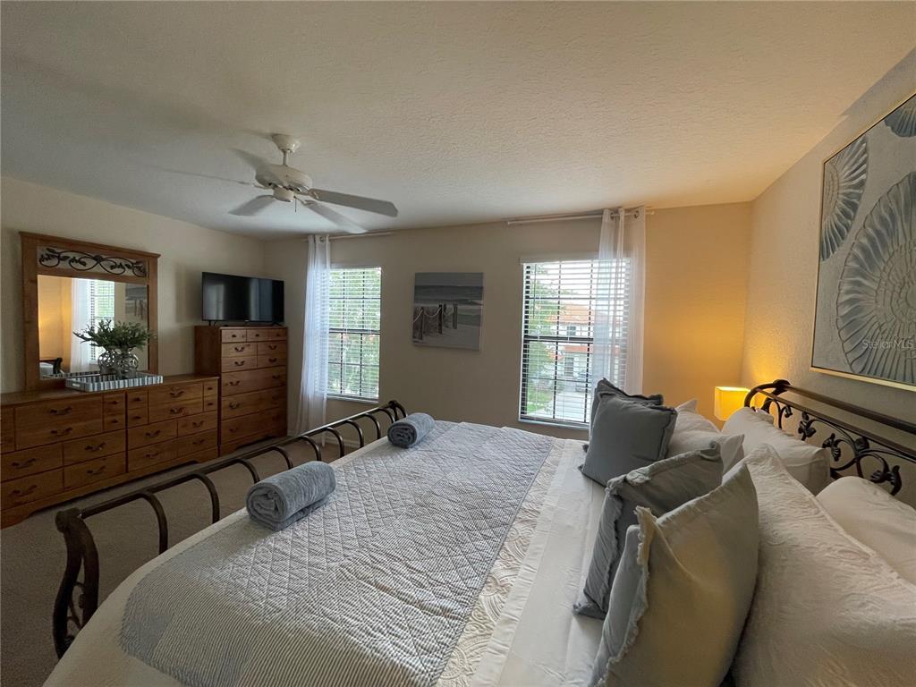 141 Summer Pl Loop Clermont, FL 34714 - Photo 28 of 63 a bedroom with a bed and wooden floor