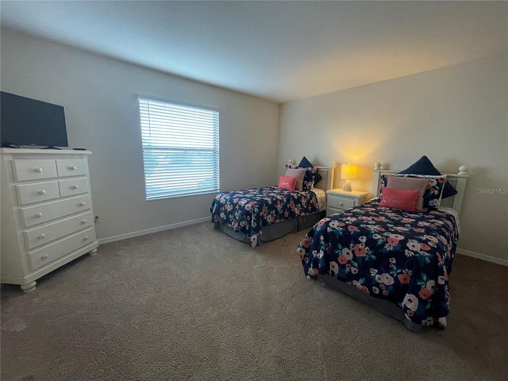 141 Summer Pl Loop Clermont, FL 34714 - Photo 31 of 63 a bedroom with two bed and a window