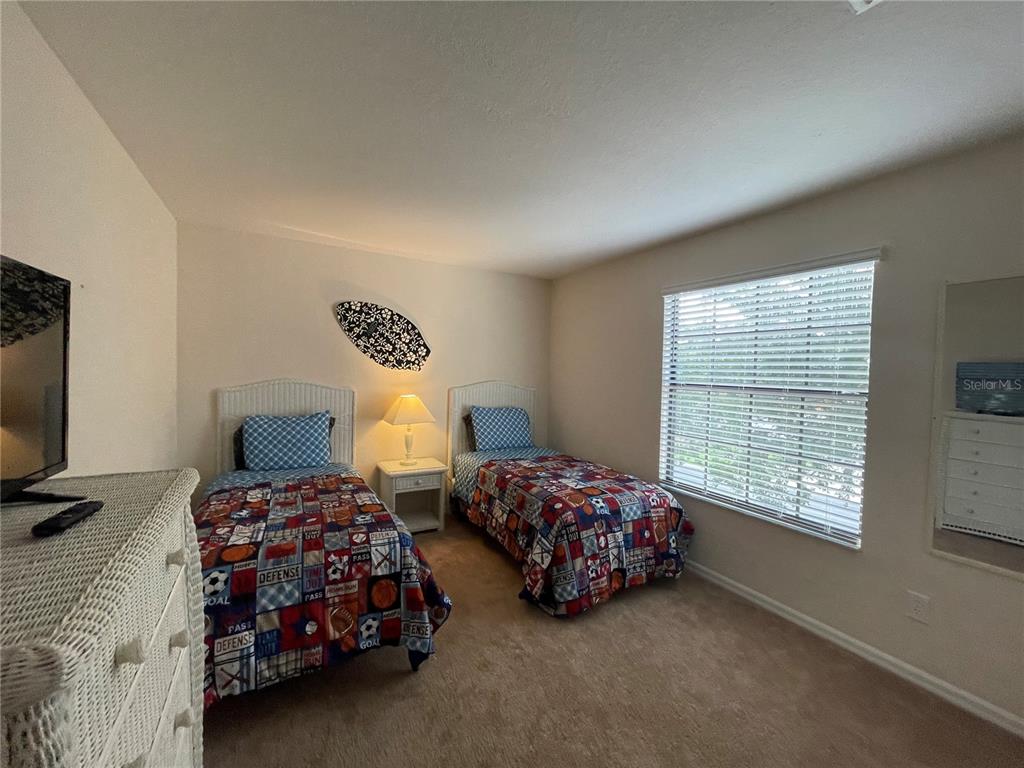 141 Summer Pl Loop Clermont, FL 34714 - Photo 35 of 63 a bedroom with two beds and a window