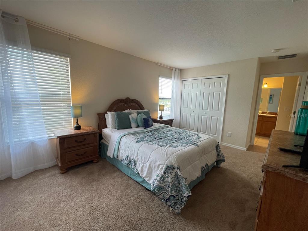 141 Summer Pl Loop Clermont, FL 34714 - Photo 37 of 63 a spacious bedroom with a bed and a couch