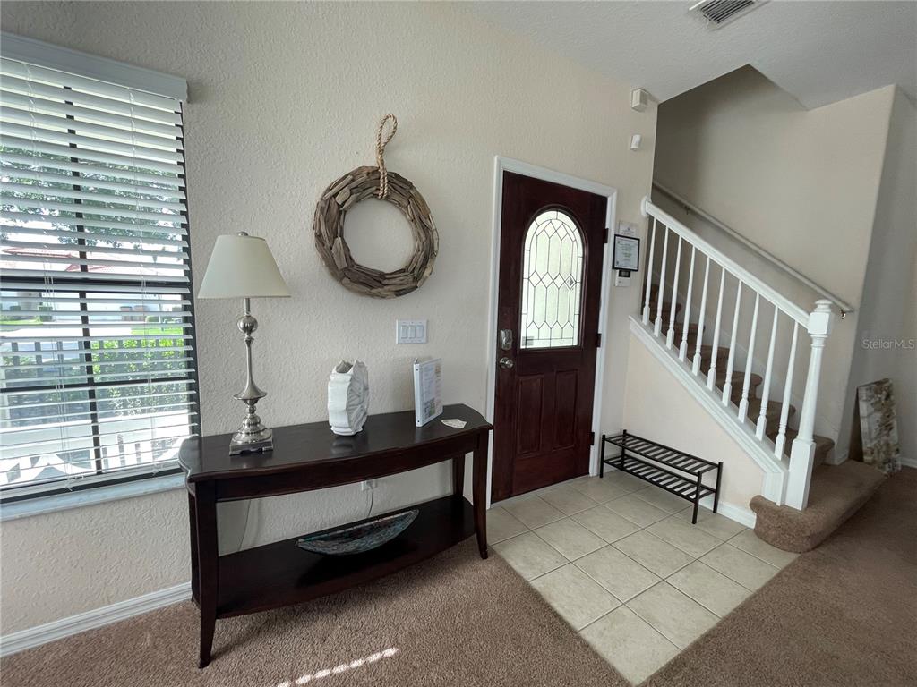141 Summer Pl Loop Clermont, FL 34714 - Photo 4 of 63 a room with lots of white furniture and a large window