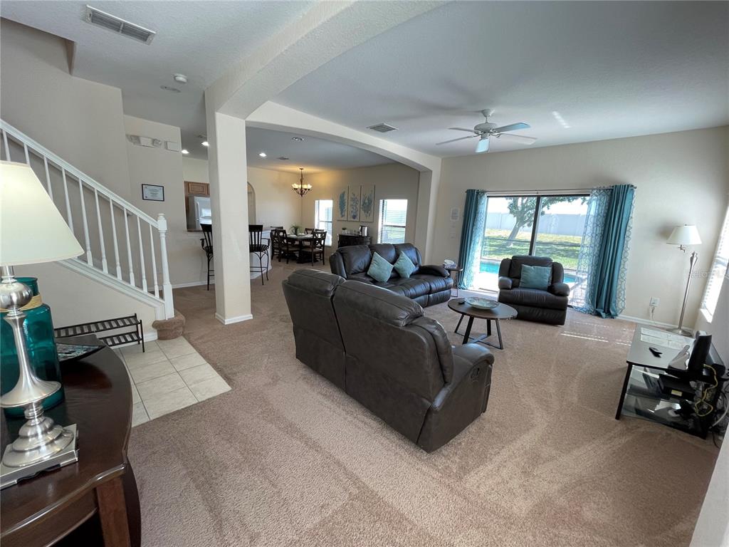 141 Summer Pl Loop Clermont, FL 34714 - Photo 5 of 63 a living room with furniture and a fireplace