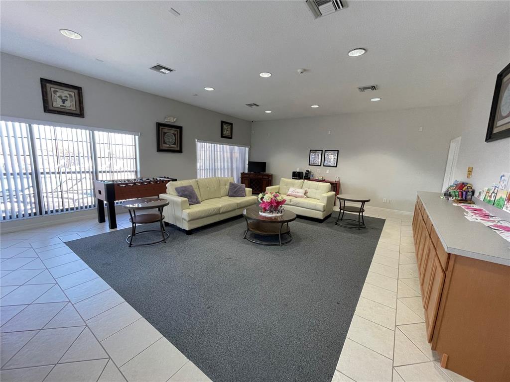 141 Summer Pl Loop Clermont, FL 34714 - Photo 57 of 63 a living room with furniture and a flat screen tv