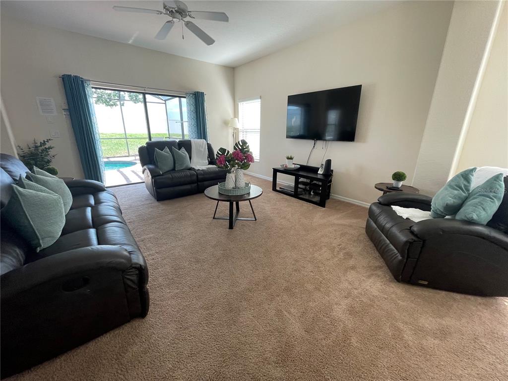 141 Summer Pl Loop Clermont, FL 34714 - Photo 6 of 63 a living room with furniture and a flat screen tv