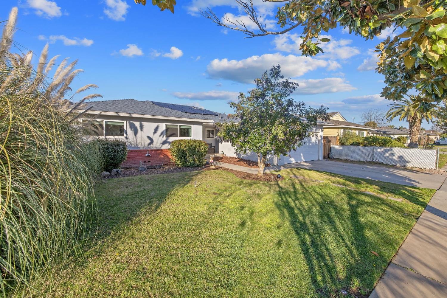 1310 East Sample Avenue Fresno, CA 93710 - Photo 2 of 30 a view of house with swimming pool yard and outdoor seating
