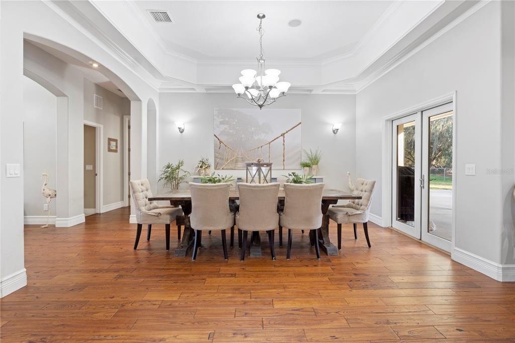 3108 Carter Jones Road Groveland, FL 34736 - Photo 11 of 54 a view of a dining room with furniture and wooden floor