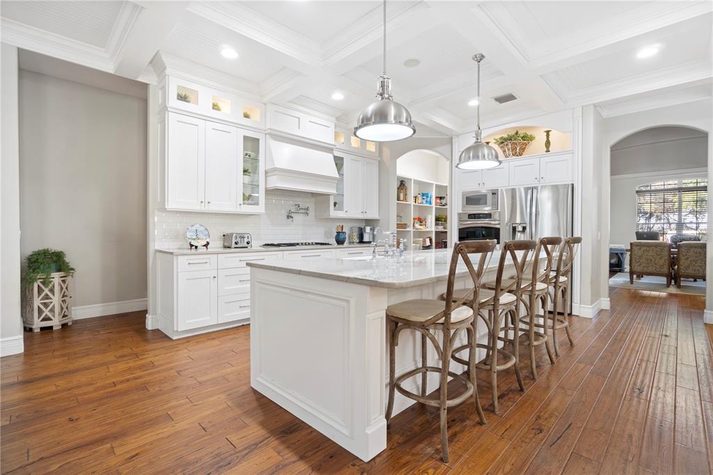 3108 Carter Jones Road Groveland, FL 34736 - Photo 13 of 54 a kitchen with stainless steel appliances kitchen island granite countertop a stove a sink and a refrigerator