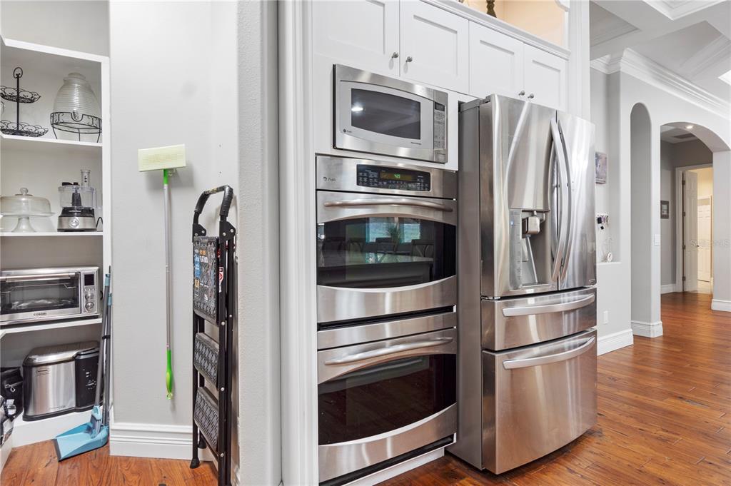 3108 Carter Jones Road Groveland, FL 34736 - Photo 15 of 54 a kitchen with stainless steel appliances and wooden floor