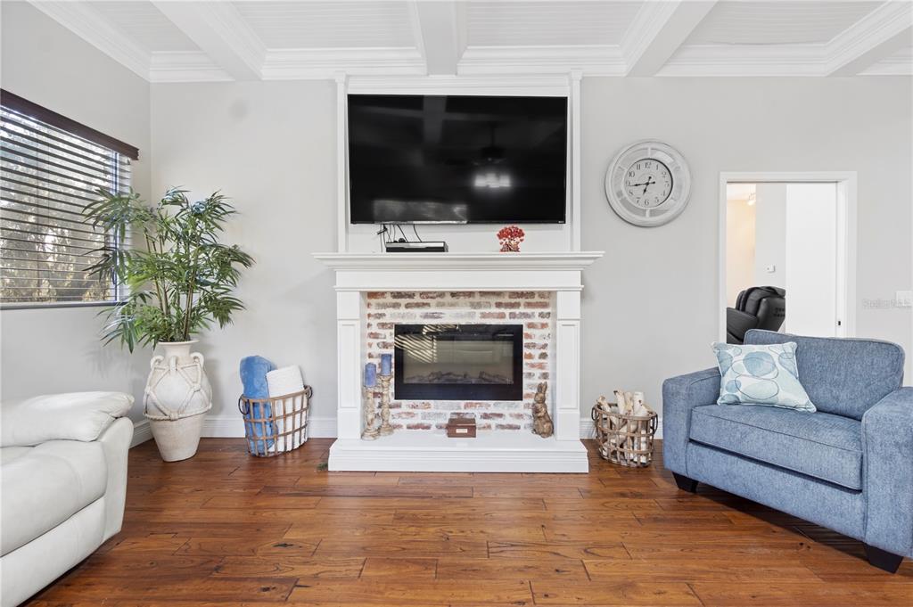 3108 Carter Jones Road Groveland, FL 34736 - Photo 20 of 54 a living room with furniture a flat screen tv and a fireplace